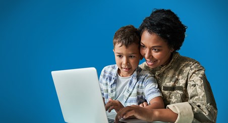 Mum and son looking at laptop together